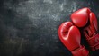 © AkuAku - Red boxing gloves closely framed empty space