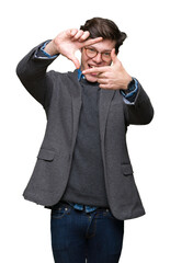 Wall Mural - Young handsome business man wearing glasses over isolated background smiling making frame with hands and fingers with happy face. Creativity and photography concept.