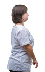 Wall Mural - Young adult woman with down syndrome over isolated background looking to side, relax profile pose with natural face with confident smile.