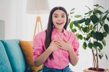 Poster - Photo of shiny impressed girl dressed pink shirt smiling having rest sofa arms chest indoors house apartment room