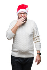 Sticker - Young caucasian man wearing christmas hat and glasses over isolated background looking stressed and nervous with hands on mouth biting nails. Anxiety problem.