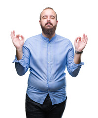 Wall Mural - Young caucasian hipster man over isolated background relax and smiling with eyes closed doing meditation gesture with fingers. Yoga concept.