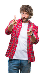 Wall Mural - Handsome hispanic model man over isolated background pointing fingers to camera with happy and funny face. Good energy and vibes.