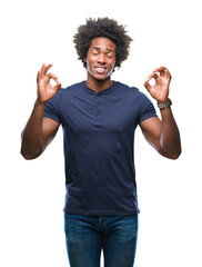 Wall Mural - Afro american man over isolated background relax and smiling with eyes closed doing meditation gesture with fingers. Yoga concept.