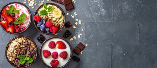 Aufkleber - Healthy breakfast concept with a frame of oatmeal bowls topped with chocolate fruit and yogurt set against a gray tiles background perfect for a copy space image
