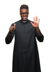 Wall Mural - Young african american priest man over isolated background showing and pointing up with fingers number six while smiling confident and happy.