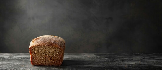 Aufkleber - Loaf of bread positioned on a dark surface with ample copy space image