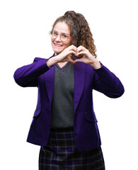 Sticker - Young brunette student girl wearing school uniform and glasses over isolated background smiling in love showing heart symbol and shape with hands. Romantic concept.