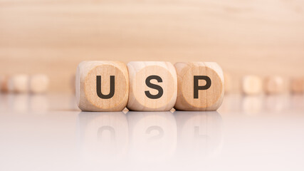 Poster - wooden cubes with letters USP. USP - short for Unique Selling Proposition