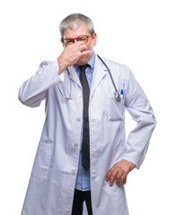 Wall Mural - Handsome senior doctor man over isolated background smelling something stinky and disgusting, intolerable smell, holding breath with fingers on nose. Bad smells concept.