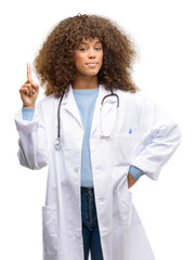 Poster - African american doctor woman, medical professional working happy and surprised cheering expressing wow gesture pointing up