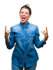 Canvas Print - Young beautiful woman over isolated background shouting with crazy expression doing rock symbol with hands up. Music star. Heavy concept.