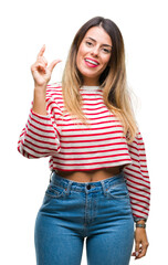 Sticker - Young beautiful woman casual stripes winter sweater over isolated background smiling and confident gesturing with hand doing size sign with fingers while looking and the camera. Measure concept.