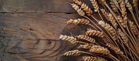 Poster - Copy space image featuring golden wheat rye ears arranged on a rustic wooden board