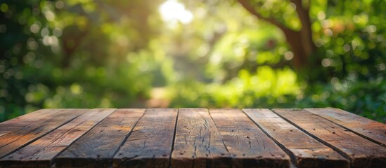 Aufkleber - Wooden table with no objects on it set against a blurred green nature backdrop creating a serene copy space image