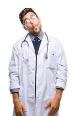 Canvas Print - Young handsome doctor man over isolated background making fish face with lips, crazy and comical gesture. Funny expression.