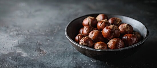 Leinwandbilder - Chestnuts cooked and crispy against a dark backdrop perfect for snacking with room for text or a logo in the image. with copy space image. Place for adding text or design