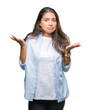 © Krakenimages.com - Young beautiful arab woman over isolated background clueless and confused expression with arms and hands raised. Doubt concept.