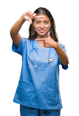 Poster - Young arab doctor surgeon woman over isolated background smiling making frame with hands and fingers with happy face. Creativity and photography concept.