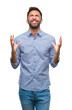 © Krakenimages.com - Adult hispanic man over isolated background crazy and mad shouting and yelling with aggressive expression and arms raised. Frustration concept.