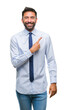 © Krakenimages.com - Adult hispanic business man over isolated background cheerful with a smile of face pointing with hand and finger up to the side with happy and natural expression on face looking at the camera.