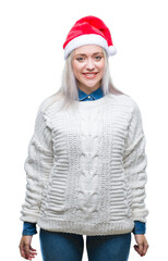 Poster - Young blonde woman wearing christmas hat over isolated background with a happy and cool smile on face. Lucky person.