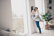© deagreez - Photo of attractive trendy cheerful married young couple kiss neck embrace husband hold wife move new apartment home interior indoors