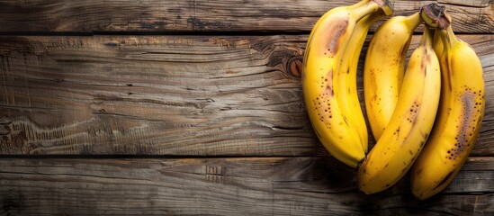 Aufkleber - Bananas bunched together on a rustic wooden kitchen table with space for text or other images. with copy space image. Place for adding text or design
