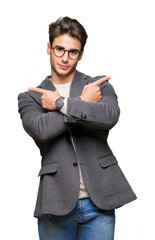 Wall Mural - Young business man wearing glasses over isolated background Pointing to both sides with fingers, different direction disagree