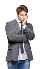 Wall Mural - Young business man wearing suit and tie over isolated background thinking looking tired and bored with depression problems with crossed arms.