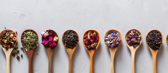 Aufkleber - Various dry tea varieties including green black floral herbal and more displayed in wooden spoons against a plain background for a food themed flat lay with copy space image