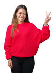 Sticker - Young beautiful brunette woman wearing red winter sweater over isolated background smiling with happy face winking at the camera doing victory sign. Number two.