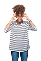 Wall Mural - Beautiful young african american woman wearing glasses over isolated background Trying to open eyes with fingers, sleepy and tired for morning fatigue