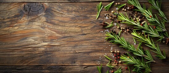 Fototapete - Rosemary arranged on a wooden surface with various spices surrounding it creating a visually appealing copy space image when viewed from the top