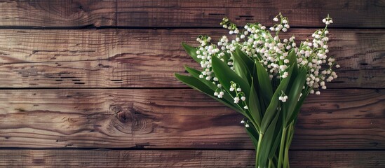 Fototapete - Aerial view of lilies of the valley bouquet on wooden backdrop with copy space image