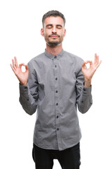 Wall Mural - Young hipster man relax and smiling with eyes closed doing meditation gesture with fingers. Yoga concept.