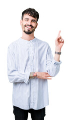 Poster - Young handsome business man over isolated background with a big smile on face, pointing with hand and finger to the side looking at the camera.