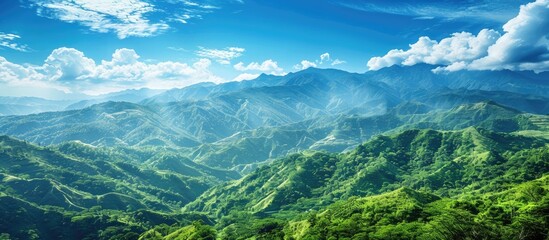 Wall Mural - Scenic view of lush green mountains against a vivid blue sky providing a serene backdrop for any copy space image