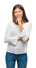 Canvas Print - Young asian woman over isolated background looking confident at the camera with smile with crossed arms and hand raised on chin. Thinking positive.