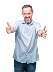 Poster - Middle age hoary senior business man over isolated background looking at the camera smiling with open arms for hug. Cheerful expression embracing happiness.