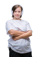 Canvas Print - Young adult woman with down syndrome wearing headphones over isolated background happy face smiling with crossed arms looking at the camera. Positive person.