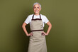 © deagreez - Photo of confident positive woman wear apron serving coffee empty space isolated khaki color background