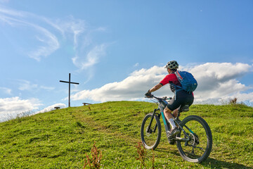 Wall Mural - nice active senior woman riding her electric mountain bike at Mount Huendle in Oberstaufen, Allgaeu Alps , Bavaria, Germany