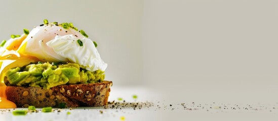 Sticker - Avocado toast topped with a perfectly poached egg displayed in a picturesque setting with ample copy space image