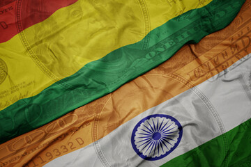 Wall Mural - waving colorful flag of india and national flag of bolivia on the dollar money background. finance concept.