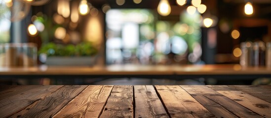 Poster - Empty brown wooden table in focus with coffee shop background blur and bokeh ideal for showcasing products in a copy space image