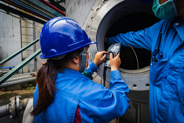 Worker female hand holding gas detector inspection safety gas testing at front manhole tank stainless chemical