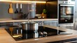 © PSCL RDL - Induction stove, oven and range hood on modern kitchen with wooden furniture. Stainless pan on glass ceramic hob. Cooking food on electric cooker at home. Household appliance. Apartment interior