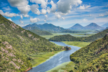 Wall Mural - captivating view of the crnojevic river bend around green mountain peaks on a sunny day.