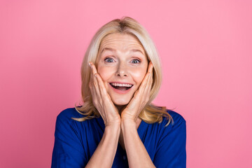 Sticker - Photo portrait of attractive retired woman touch cheeks amazed dressed stylish blue clothes isolated on pink color background